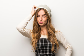 Fashionably woman wearing hat with an expression of frustration and not understanding