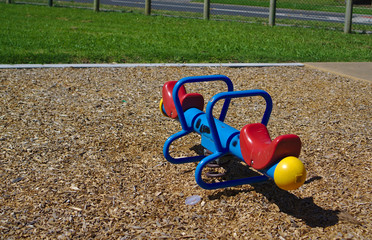 Colorful seesaw on brown wooden pieces ground