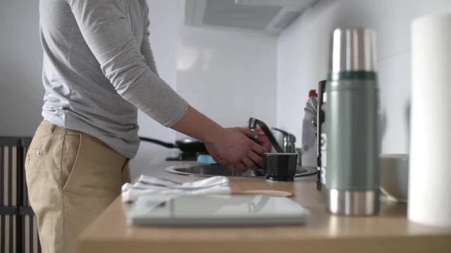 A Man Washing Coffee Mocco at the Kitchen at Home - Day
