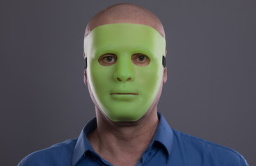 man in an alien mask