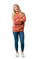 A full-length shot of a Young girl keeping the arms crossed in frontal position on isolated white background