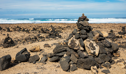 Stones pyramid on sand symbolizing zen, harmony, Stone balancing
