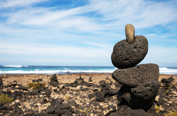 Stones pyramid on sand symbolizing zen, harmony, Stone balancing
