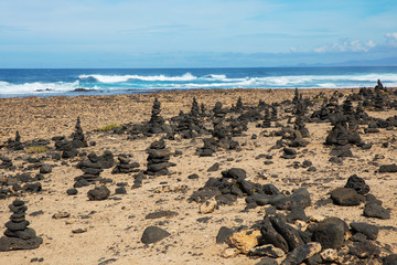 Stones pyramid on sand symbolizing zen, harmony, Stone balancing
