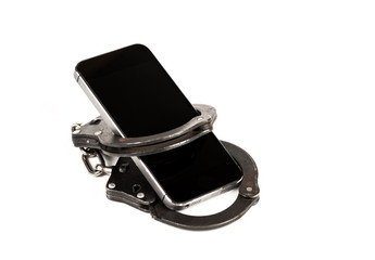 phone and the handcuffs. the concept of dependence on the Internet,technology and social networks. isolated on white background.