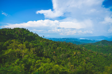 Fototapeta premium Blue sky high peak mountains fog hills mist scenery national park views at Phu Tub Berk, Khao Koh, Phetchabun Province, Thailand