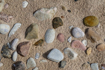 Fototapeta na wymiar sandy sea beach with rocks and low tide in overcast day