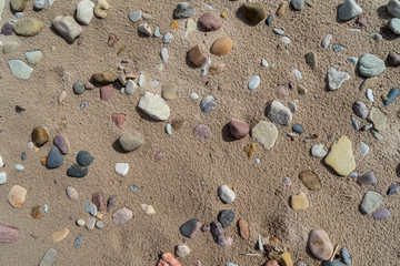sandy sea beach with rocks and low tide in overcast day