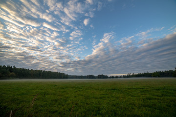high contrast clouds on blue sky over natural landscape