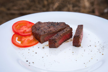 Grilled steak delicious beef meat on a white plate on a light background menu