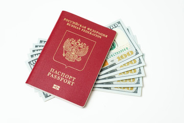 Biometric travel passport of the Russian Federation with dollars isolated on white background. Five bills for a hundred dollars. The concept of tourism. The concept of investment. Closeup.