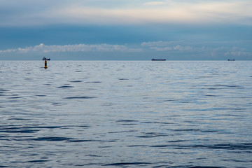 dramatic high contrast clouds in sunset over seaside beach
