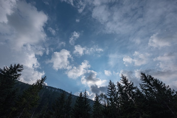 high contrast clouds on blue sky over natural landscape