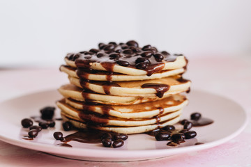 Stack of delicious homemade pancakes with sauce