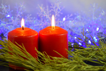 Red candles on the background of lights.Christmas card.