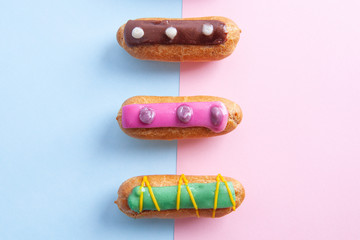 Closeup of three colorfully decorated eclairs.