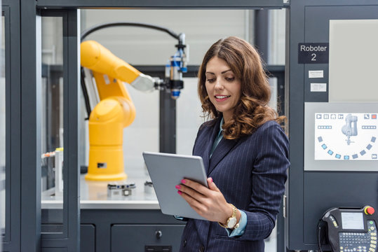 Businesswoman, working in high tech company, using digital tablet