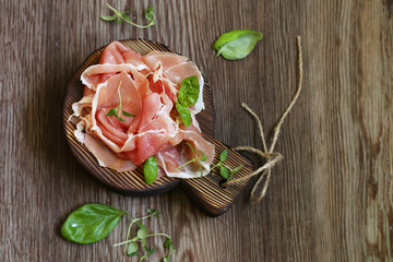 Parma italian dried ham on a wooden board - obrazy, fototapety, plakaty