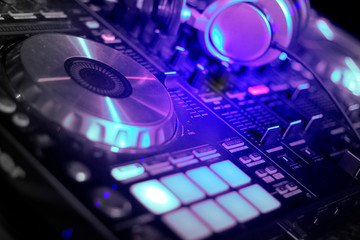 Fototapeta na wymiar Headphone and DJ control gear, electronic night party