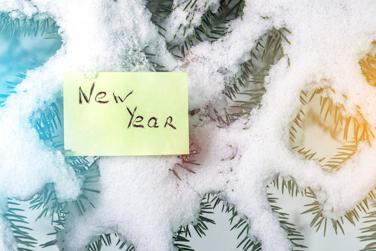 winter tree under the snow with a sticker and inscription new yea - Powered by Adobe