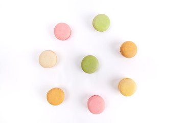 Colorful macarons arranged in a circle isolated on white background, top view
