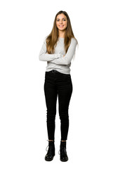 Full-length shot of young girl keeping the arms crossed in frontal position on isolated white background