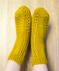 A woman wwearing colorful knitted wool socks.