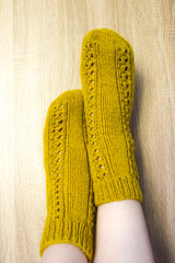 A woman wwearing colorful knitted wool socks.
