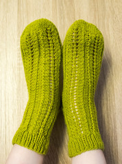 A woman wwearing colorful knitted wool socks.