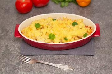 Cauliflower, tomatoes and cheese gratin in the baking dish