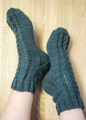 A woman wwearing colorful knitted wool socks.