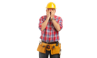 Builder rubbing eyes with hands.