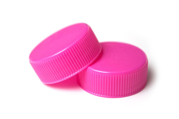 closeup of pink plastic plugs for recycling on white background