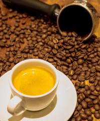 cup of coffee and beans on wooden table