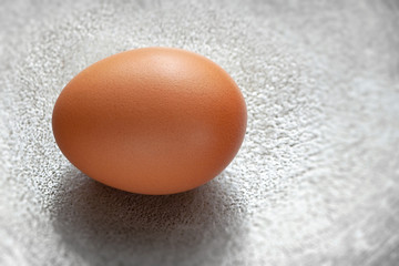 brown egg on a metallic background.