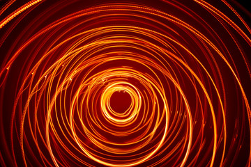 A beautiful, bright light swirl of red color. Futuristic light painting on a black background....