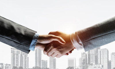 Business handshake as idea for unity and cooperation or greeting