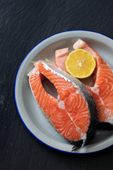 raw salmon with lemon on dish