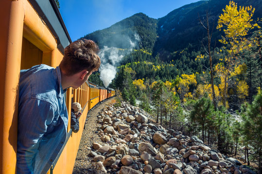 Young man looking out of train window
