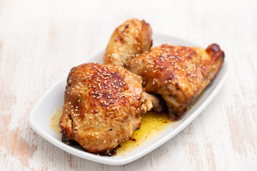 fried chicken with sauce and sesame on white dish