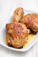 fried chicken with sauce and sesame on white dish