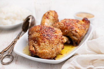fried chicken with sauce and sesame on white dish