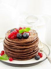 Chocolate pancakes with berries.