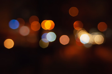 Blurred night background of city street road with bokeh effect. Abstract wallpaper for design and editing images.