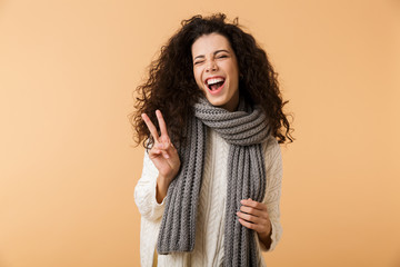 Cheerful young woman wearing winter scarf