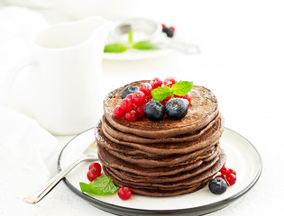 Chocolate pancakes with berries.
