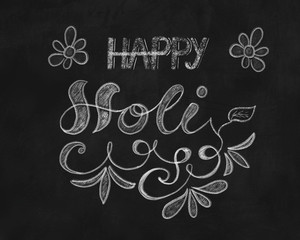 Happy Holi chalk hand lettering with ornaments on black background