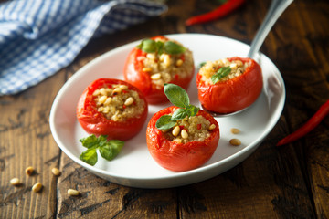 Quinoa stuffed tomatoes with pine nuts and basil