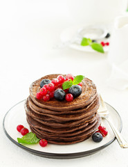 Chocolate pancakes with berries.