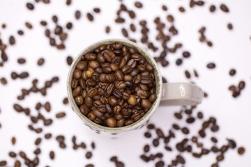 Coffee beans in cup white background